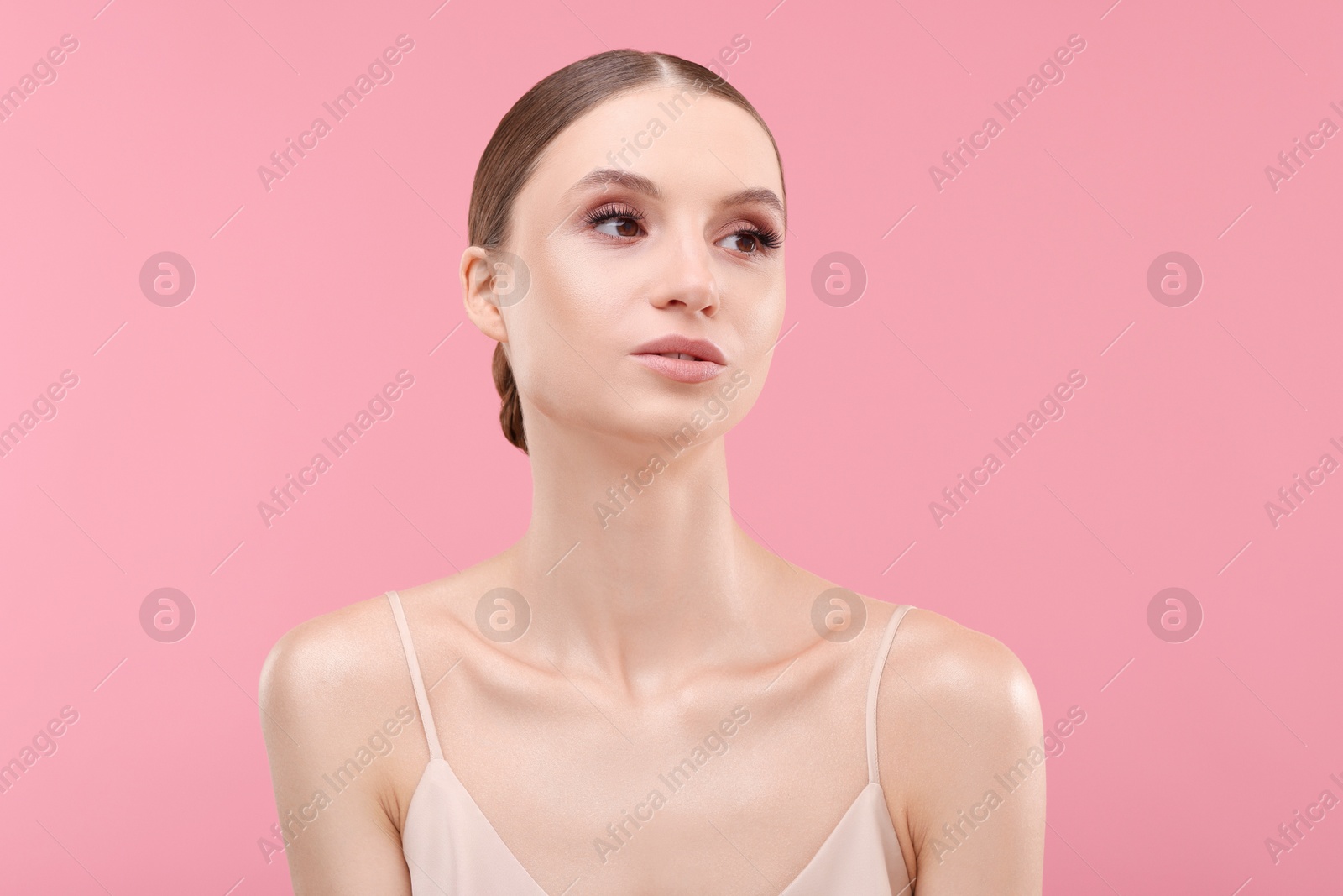 Photo of Portrait of beautiful young woman on pink background
