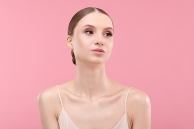 Photo of Portrait of beautiful young woman on pink background