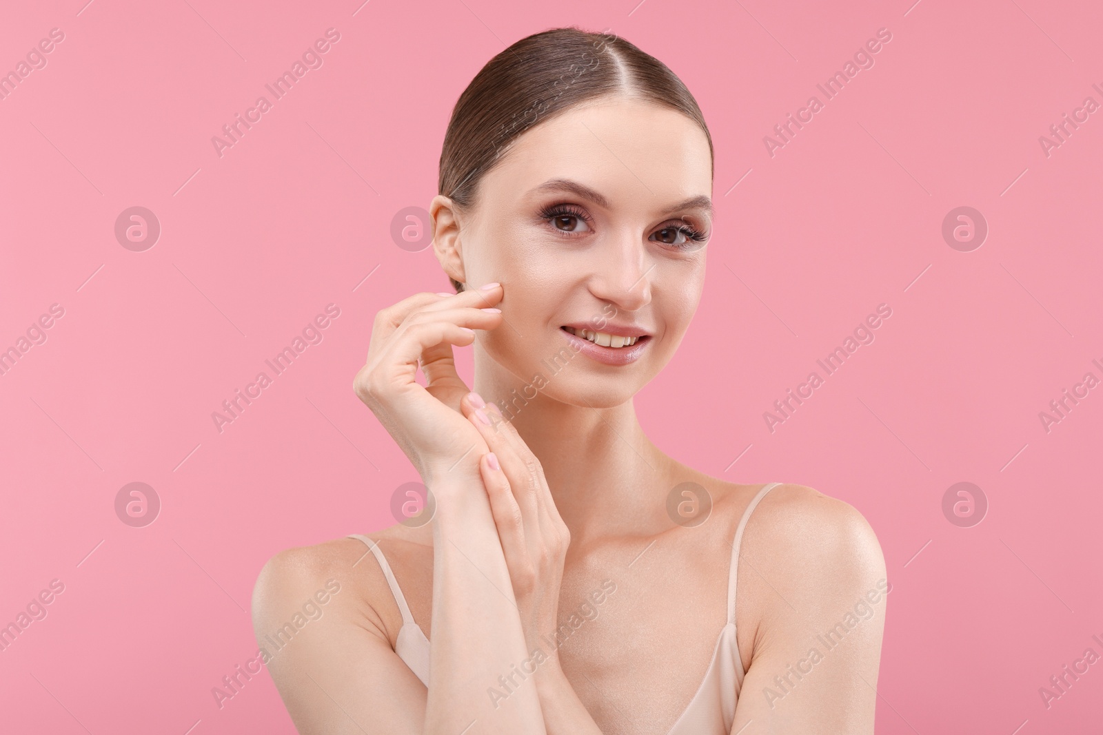 Photo of Portrait of beautiful young woman on pink background