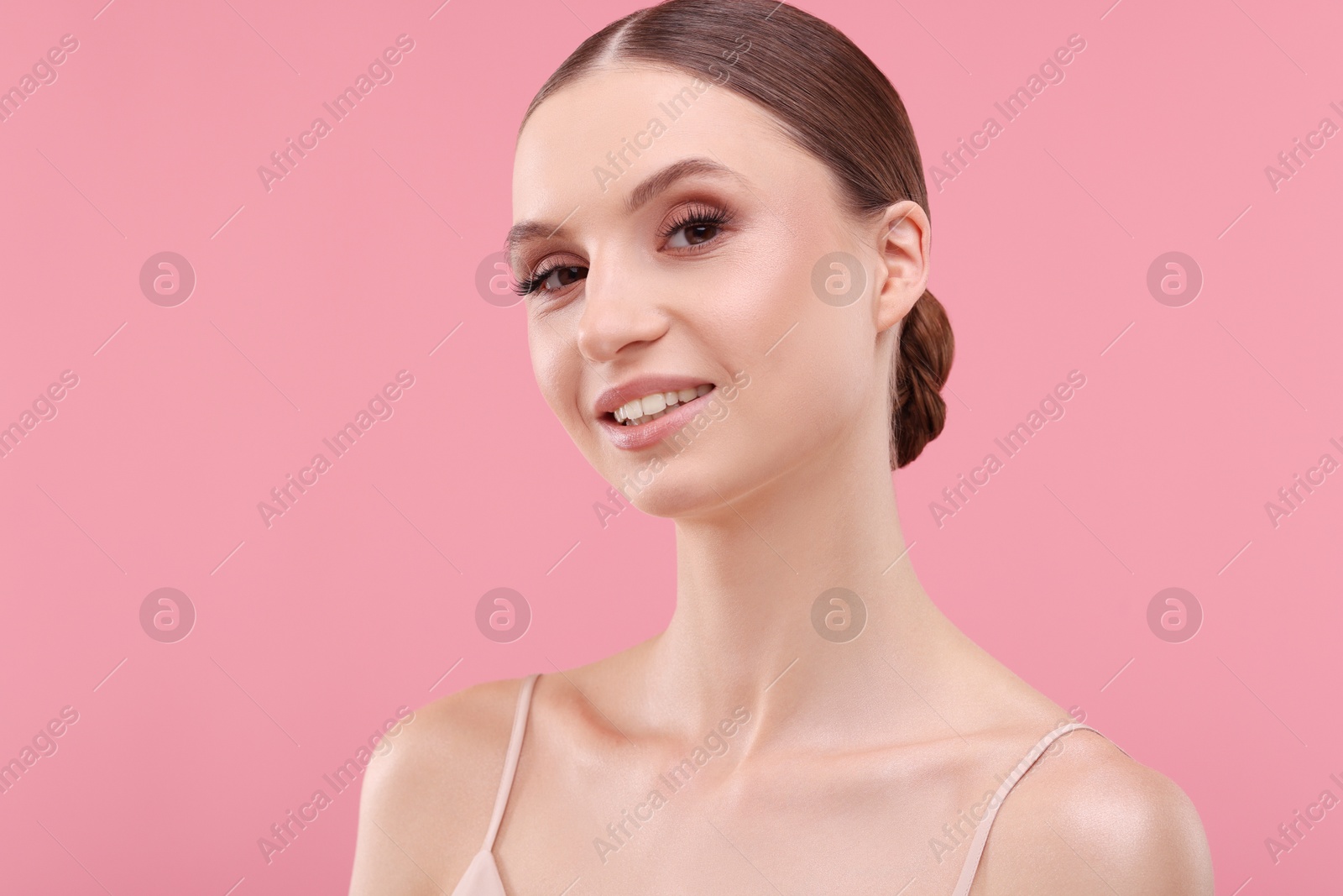 Photo of Portrait of beautiful young woman on pink background