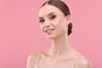 Photo of Portrait of beautiful young woman on pink background