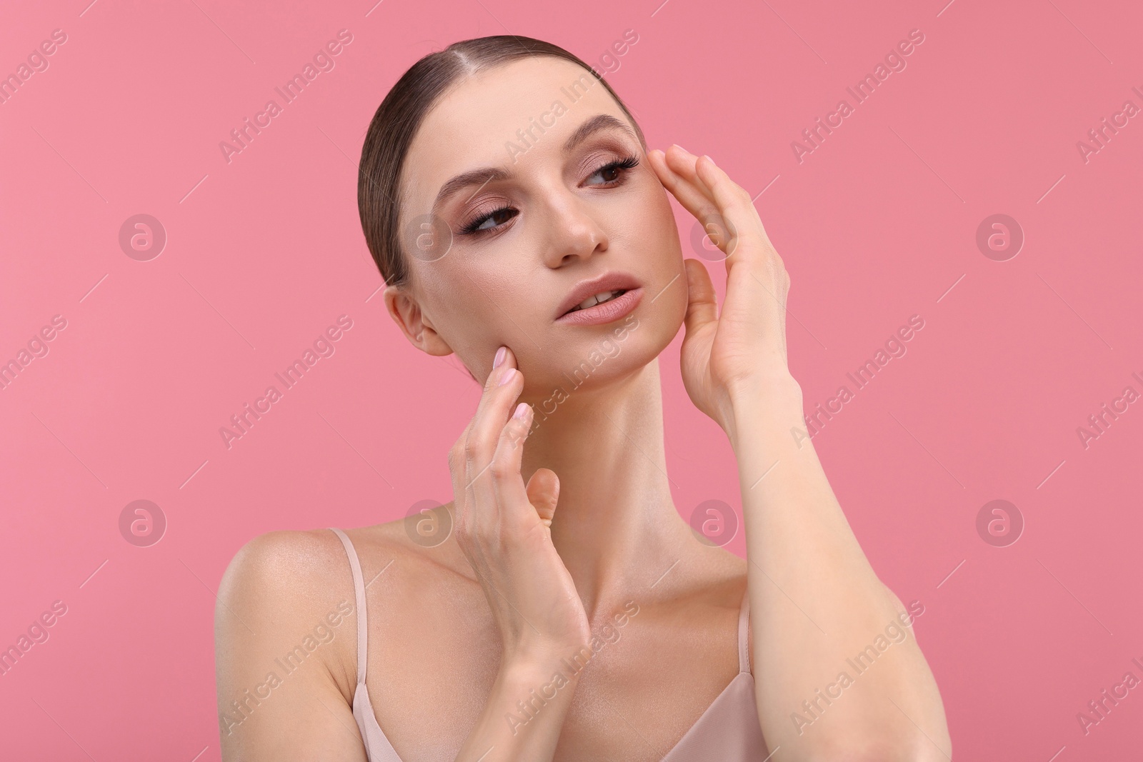 Photo of Portrait of beautiful young woman on pink background
