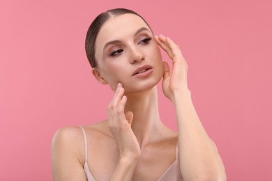 Photo of Portrait of beautiful young woman on pink background