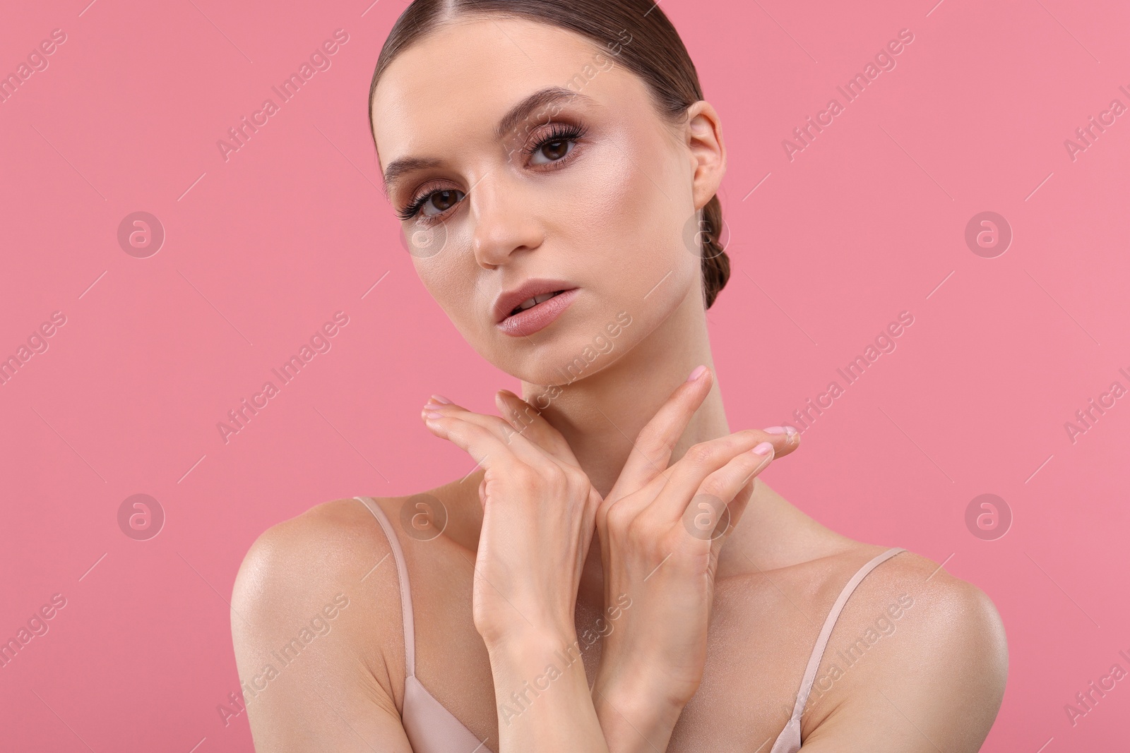 Photo of Portrait of beautiful young woman on pink background