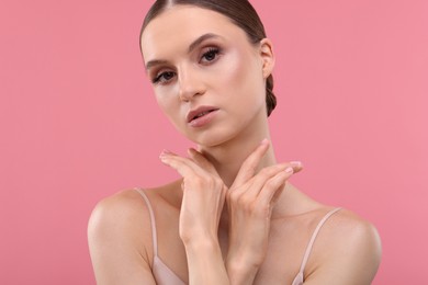 Photo of Portrait of beautiful young woman on pink background
