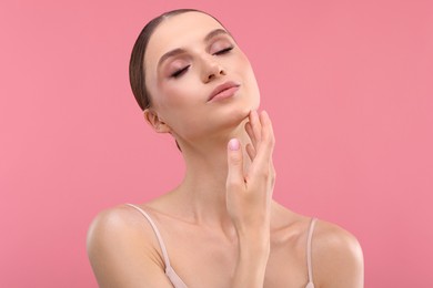 Photo of Portrait of beautiful young woman on pink background
