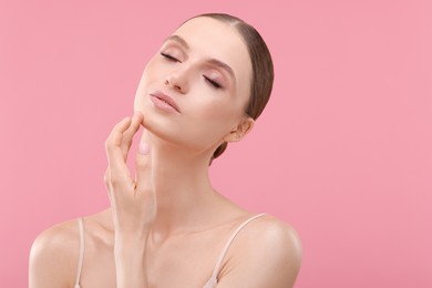 Photo of Portrait of beautiful young woman on pink background