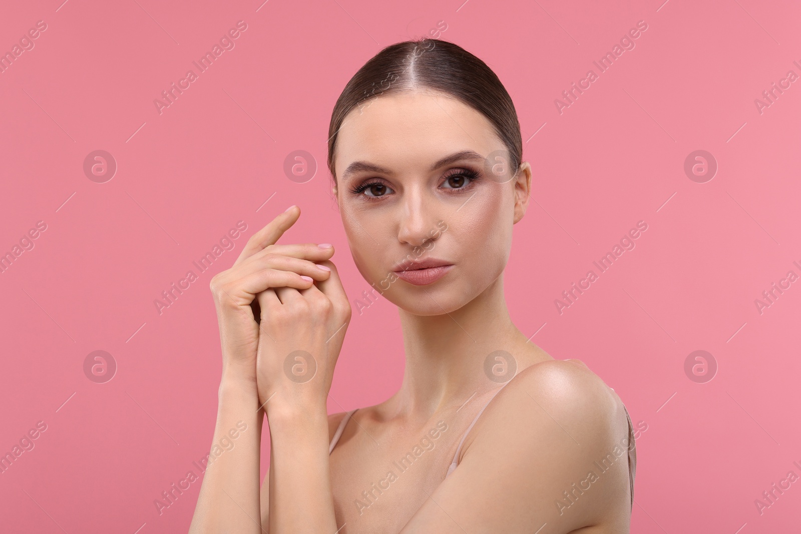 Portrait of beautiful young woman on pink background Photo of Portrait of beautiful young woman on pink background