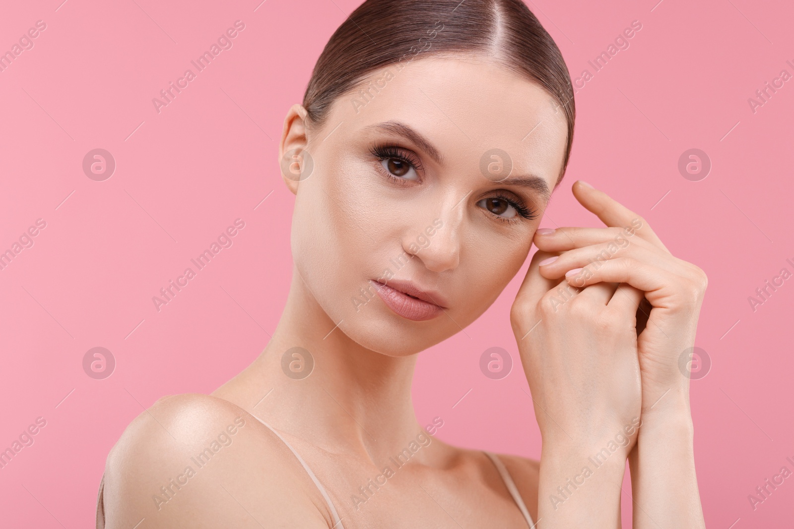Portrait of beautiful young woman on pink background, closeup Photo of Portrait of beautiful young woman on pink background, closeup