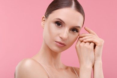 Photo of Portrait of beautiful young woman on pink background, closeup