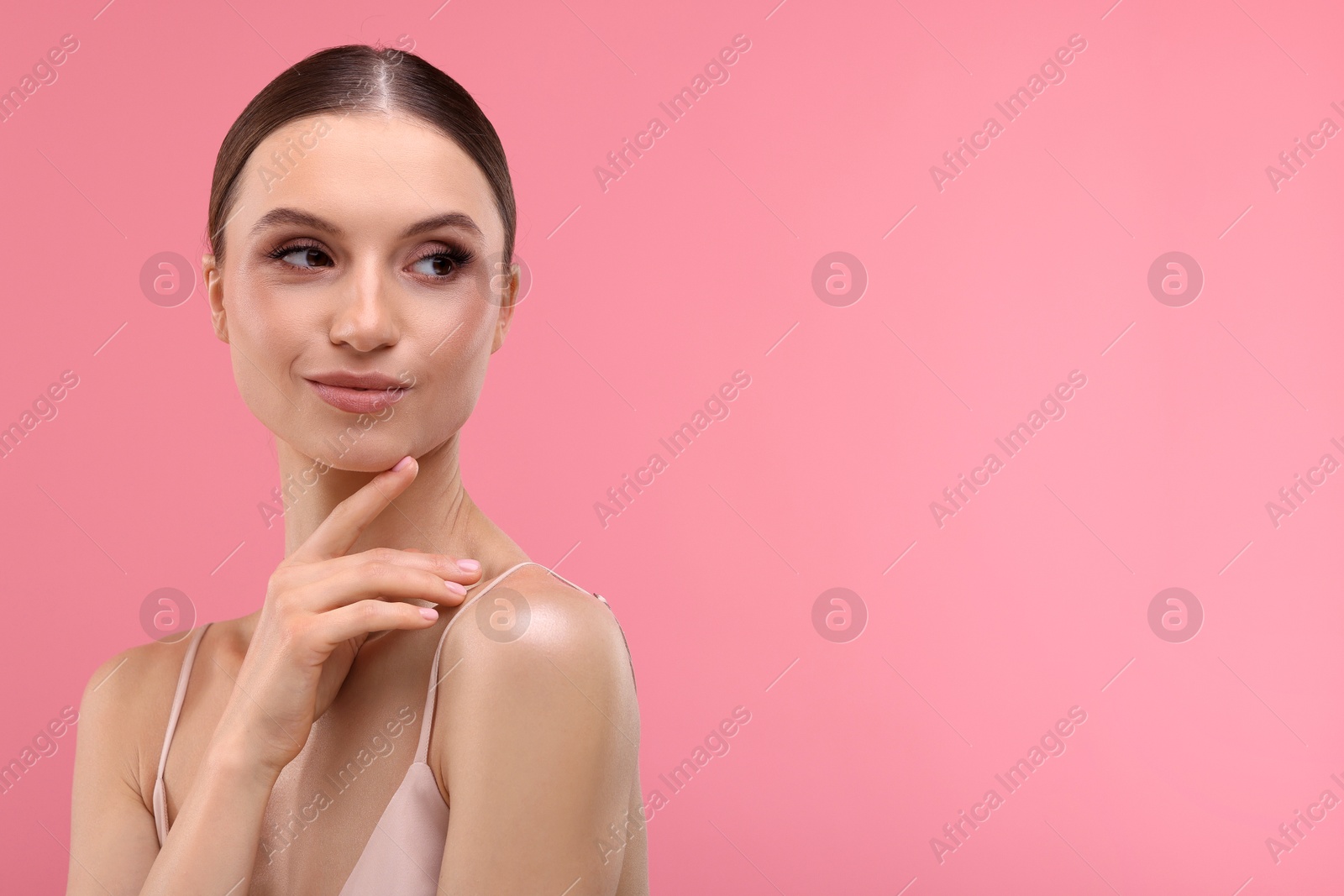 Portrait of beautiful young woman on pink background, space for text Photo of Portrait of beautiful young woman on pink background, space for text