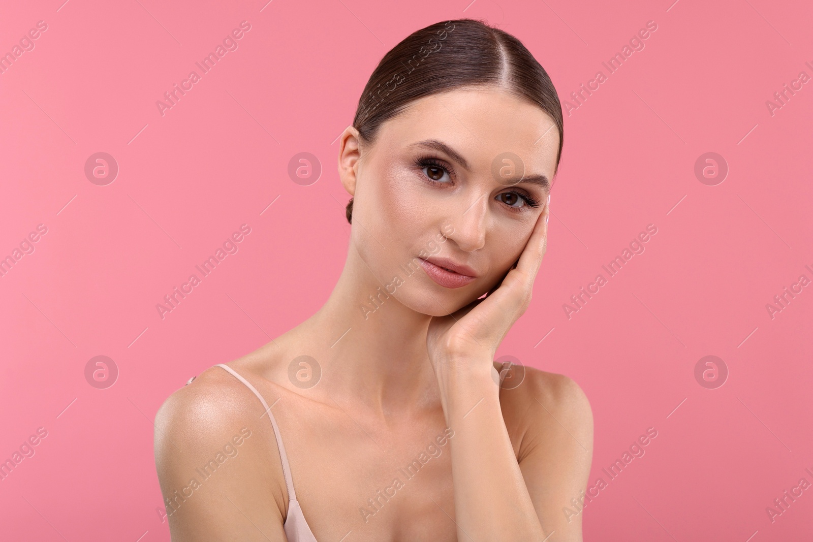 Photo of Portrait of beautiful young woman on pink background