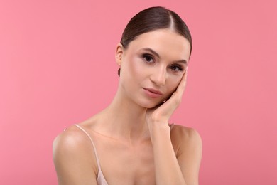 Photo of Portrait of beautiful young woman on pink background