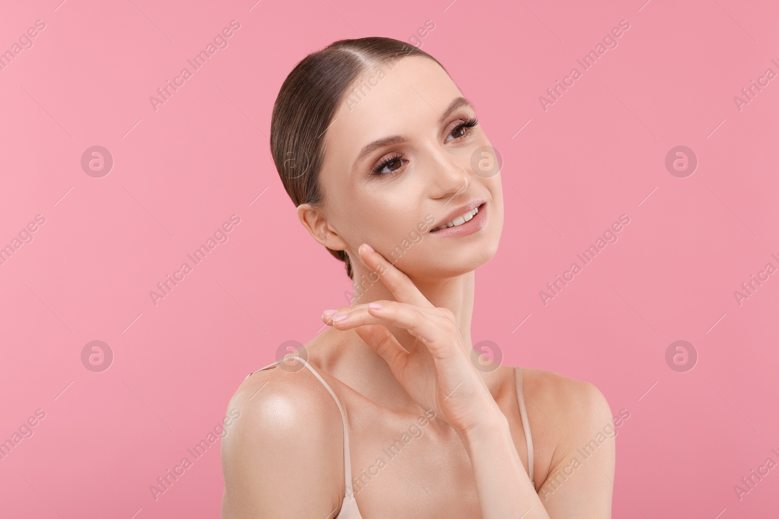 Photo of Portrait of beautiful young woman on pink background