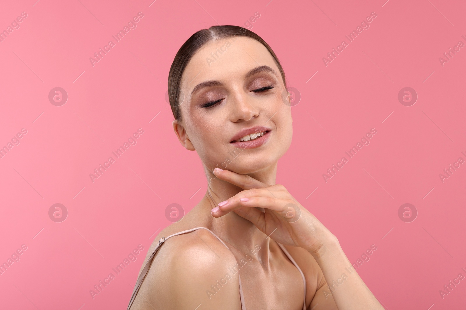Photo of Portrait of beautiful young woman on pink background