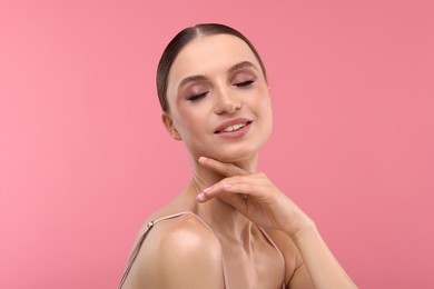 Photo of Portrait of beautiful young woman on pink background