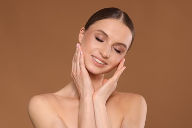 Photo of Portrait of beautiful young woman on beige background