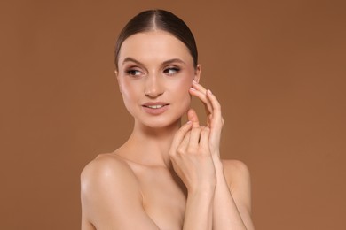 Photo of Portrait of beautiful young woman on beige background