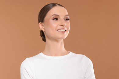 Photo of Portrait of beautiful young woman on beige background