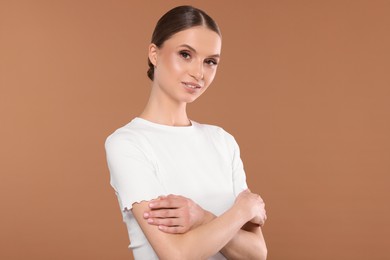Photo of Portrait of beautiful young woman on beige background