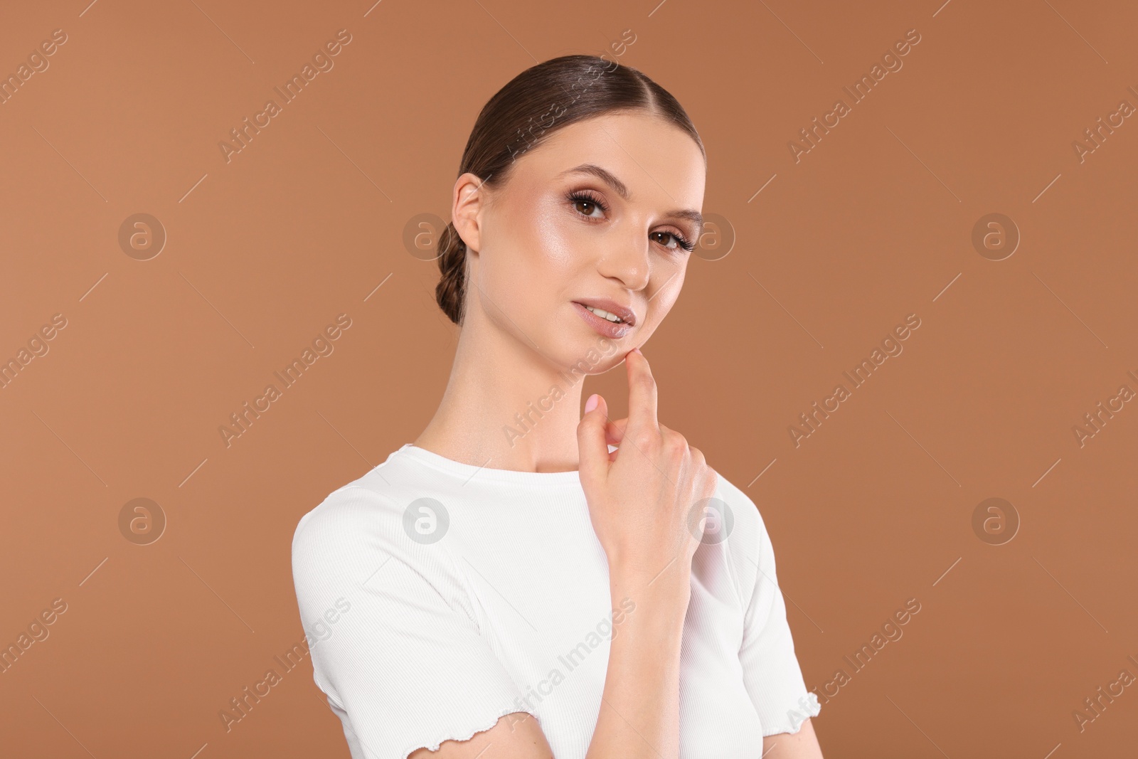 Portrait of beautiful young woman on beige background Photo of Portrait of beautiful young woman on beige background
