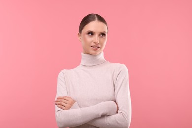 Photo of Portrait of beautiful young woman on pink background,
