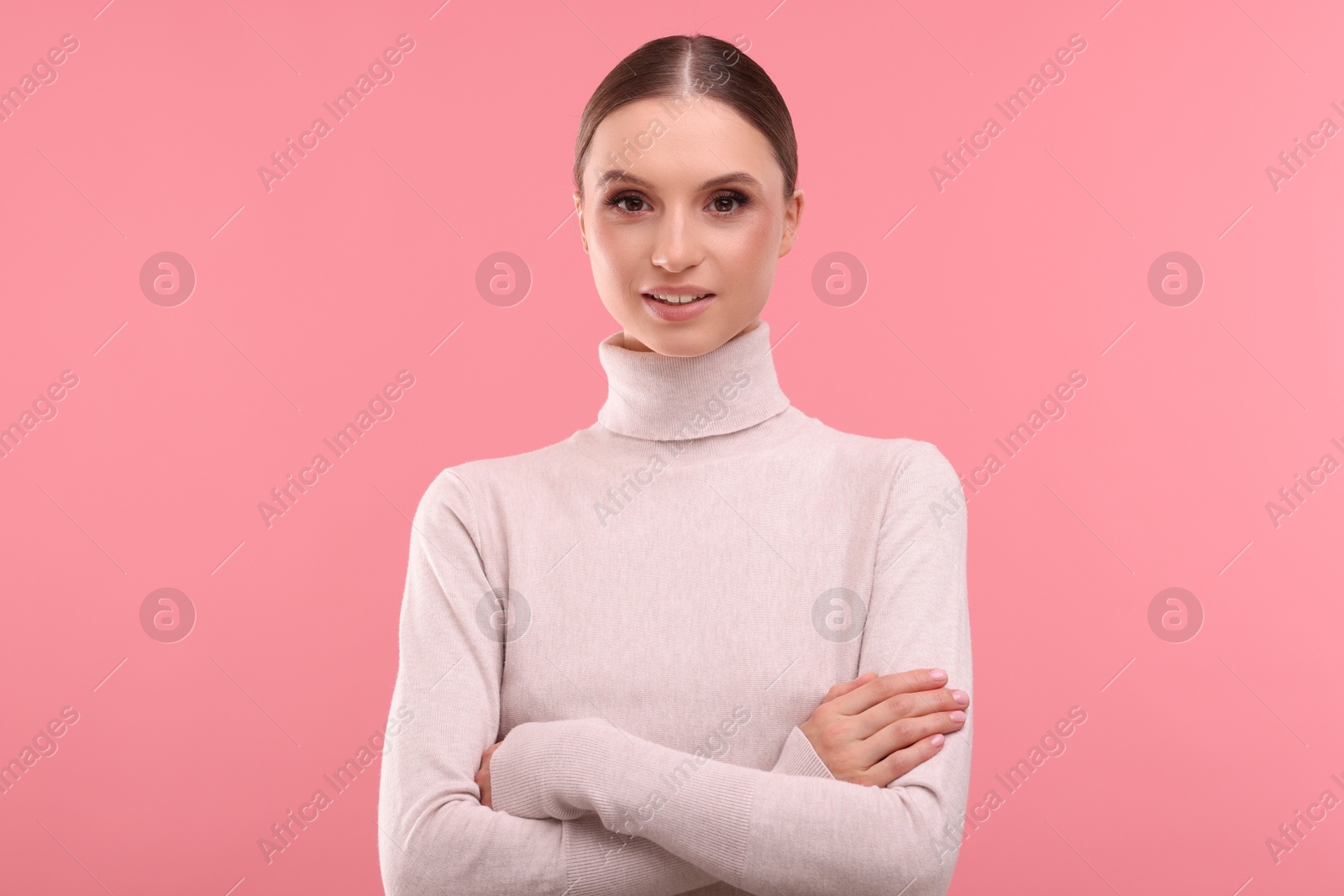 Photo of Portrait of beautiful young woman on pink background,