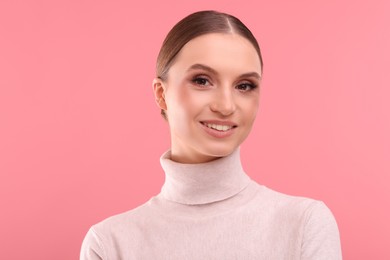 Photo of Portrait of beautiful young woman on pink background, space for text