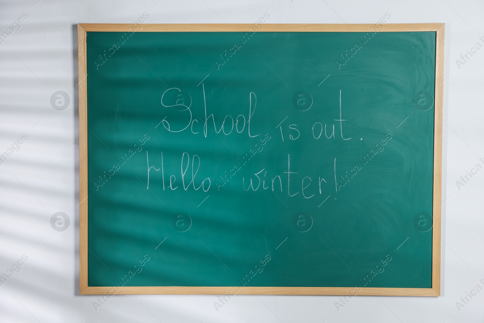 Phrases School Is Out and Hello Winter with exclamation mark on blackboard Photo of Phrases School Is Out and Hello Winter with exclamation mark on blackboard