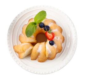 Photo of Tasty bundt cake with powdered sugar, berries and mint isolated on white, top view
