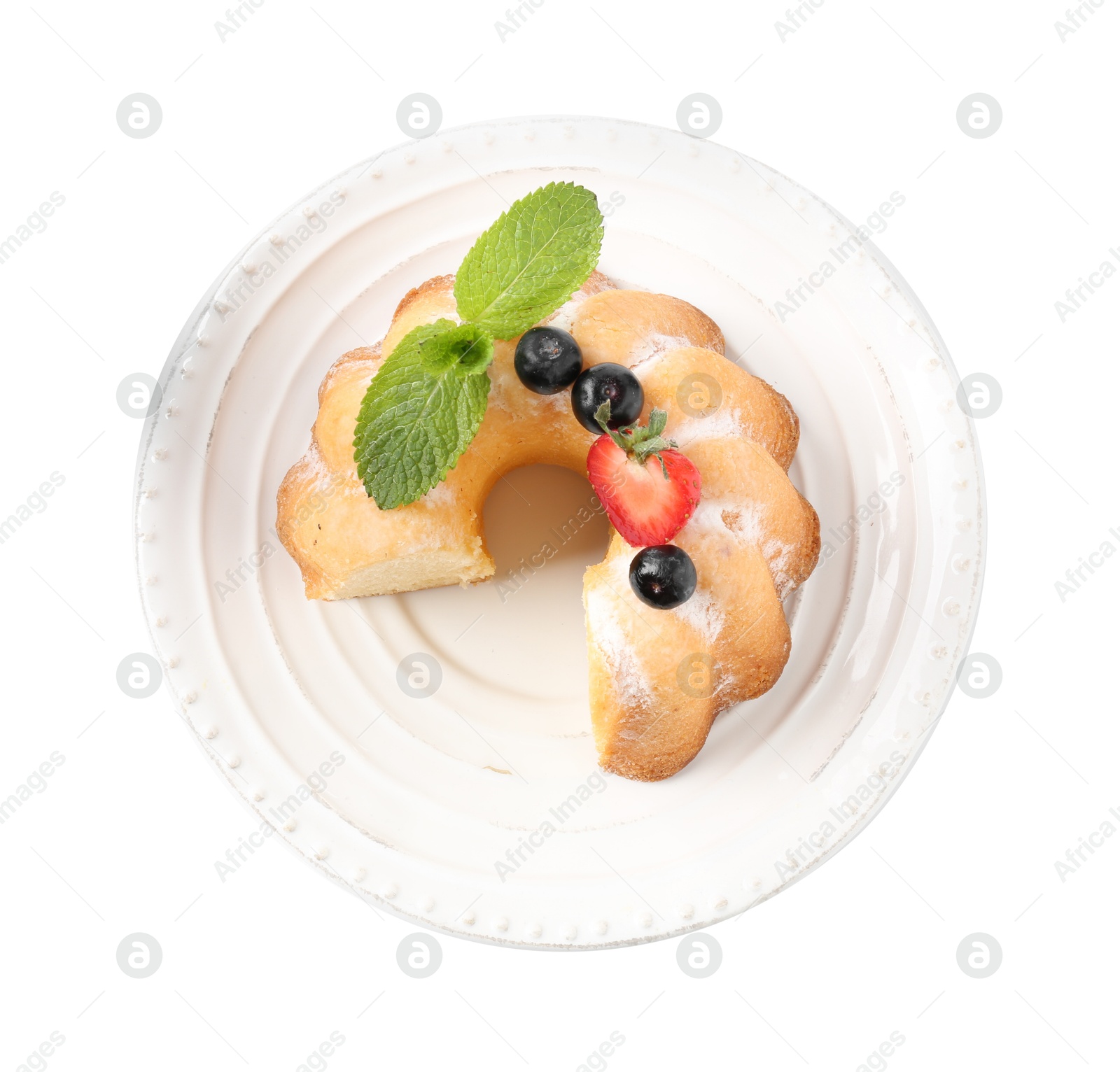 Tasty bundt cake with powdered sugar, berries and mint isolated on white, top view Photo of Tasty bundt cake with powdered sugar, berries and mint isolated on white, top view