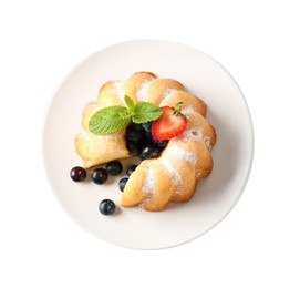 Photo of Tasty bundt cake with powdered sugar, berries and mint isolated on white, top view