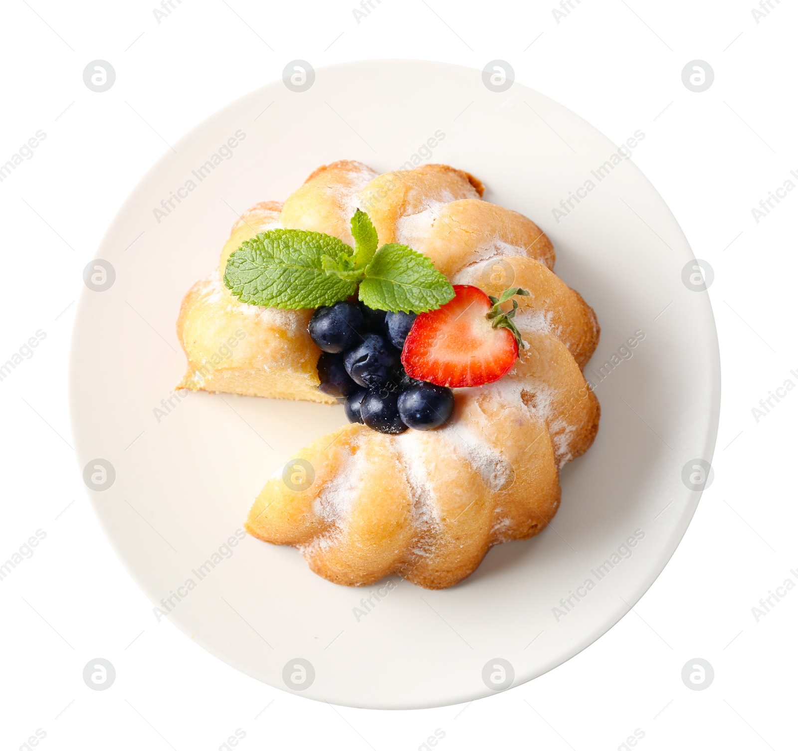 Tasty bundt cake with powdered sugar, berries and mint isolated on white, top view Photo of Tasty bundt cake with powdered sugar, berries and mint isolated on white, top view