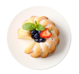 Photo of Tasty bundt cake with powdered sugar, berries and mint isolated on white, top view