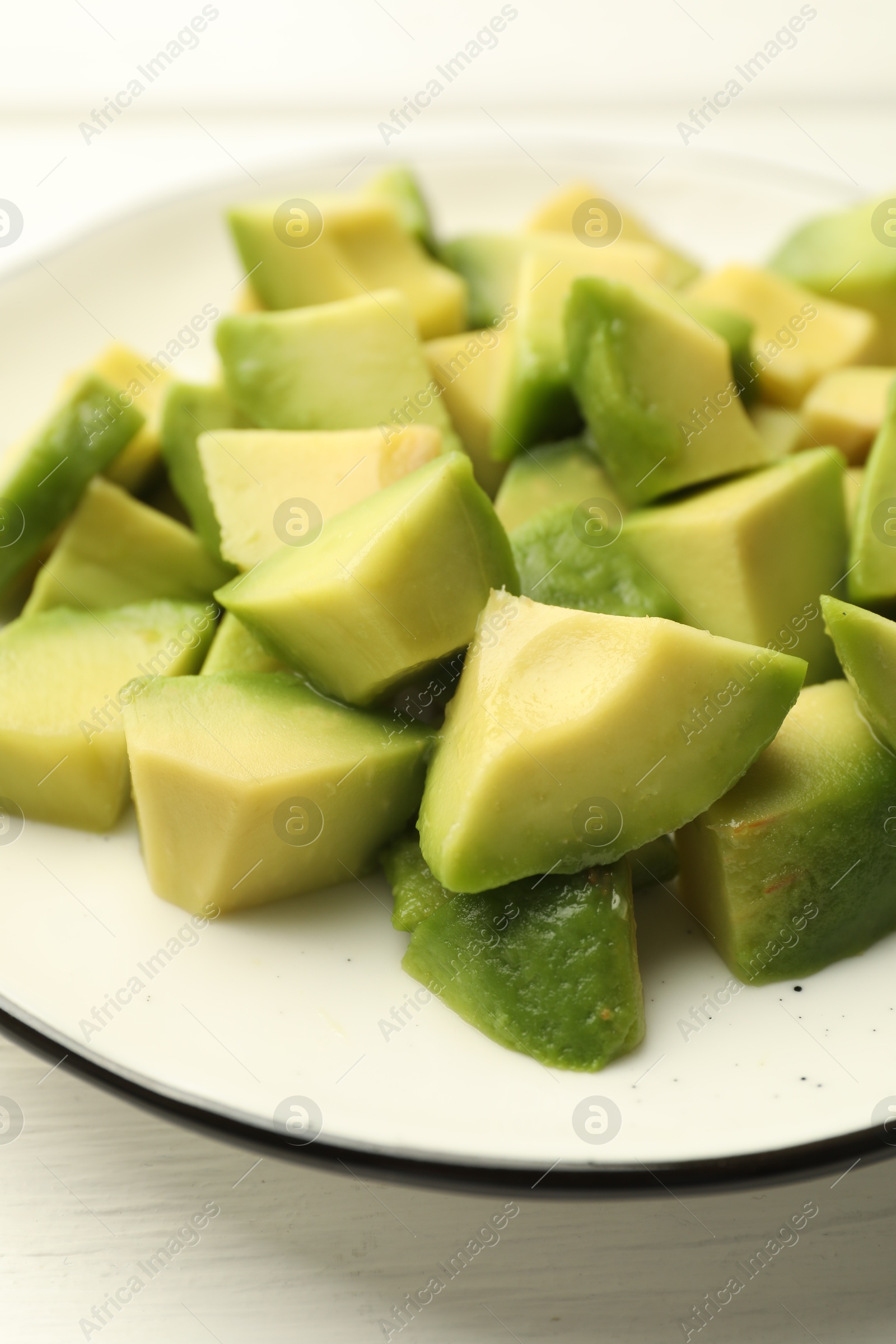 Tasty cut avocados on white wooden table, closeup Photo of Tasty cut avocados on white wooden table, closeup