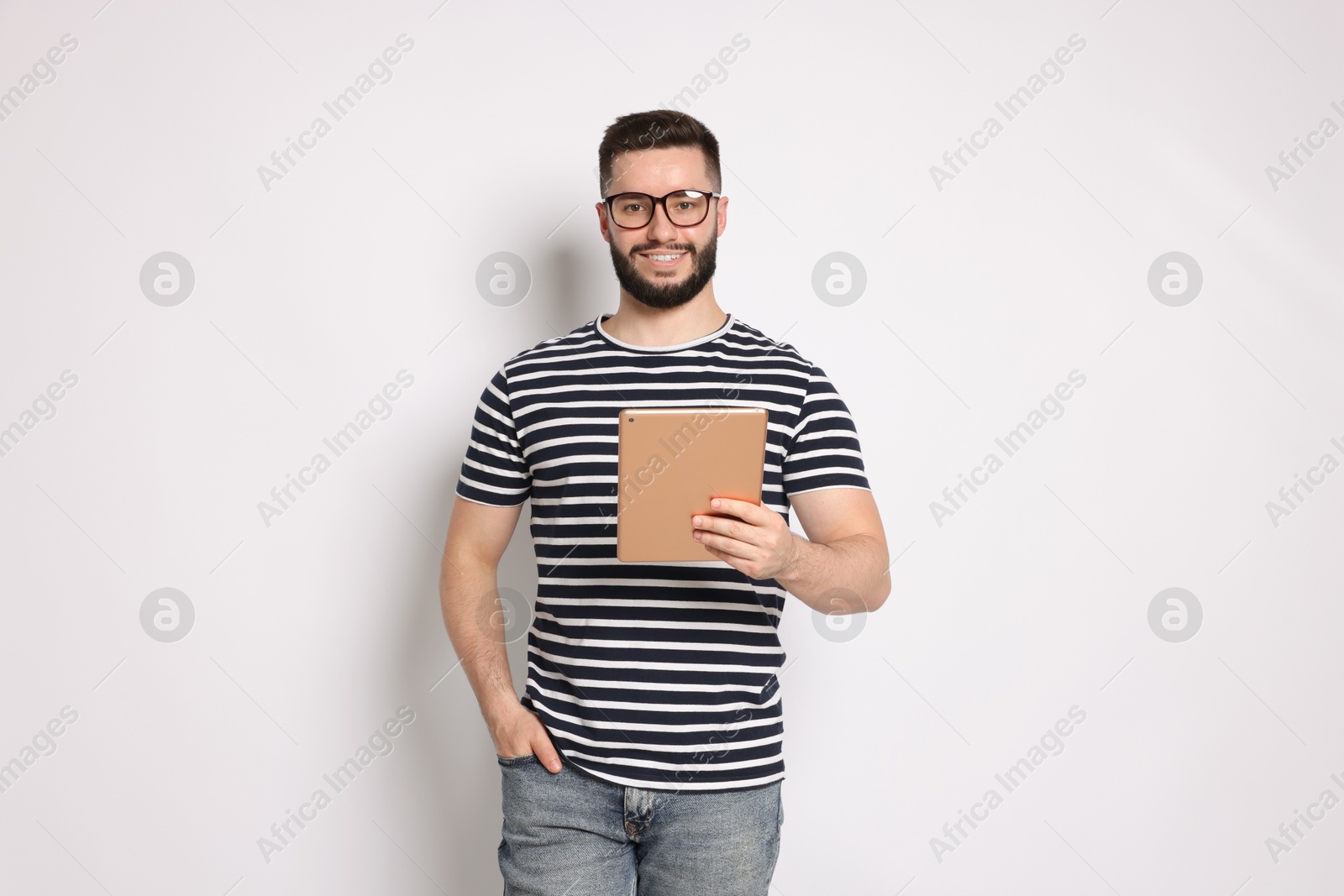 Handsome man using tablet on white background Photo of Handsome man using tablet on white background
