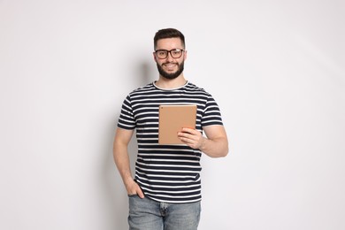 Photo of Handsome man using tablet on white background