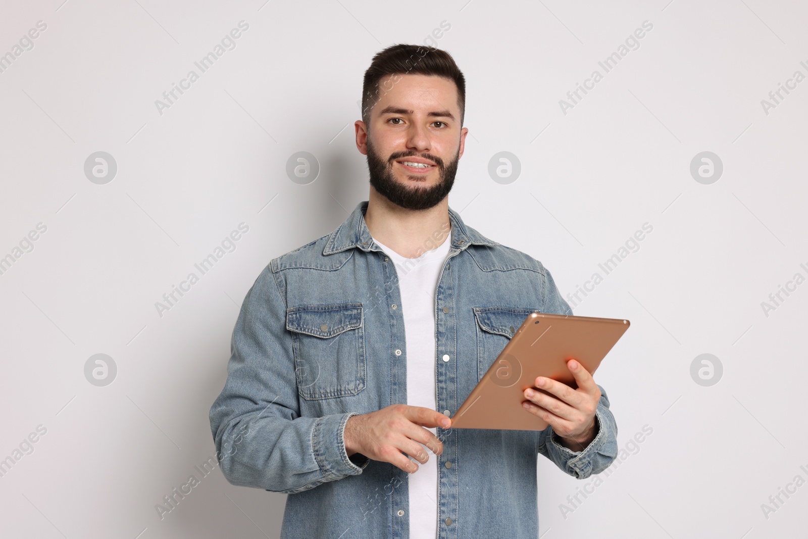 Handsome man using tablet on white background Photo of Handsome man using tablet on white background