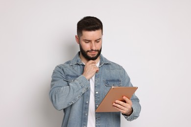 Photo of Handsome man using tablet on white background