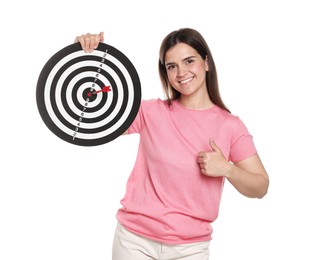 Photo of Targeting. Smiling woman with dart board and arrow showing thumbs up on white background