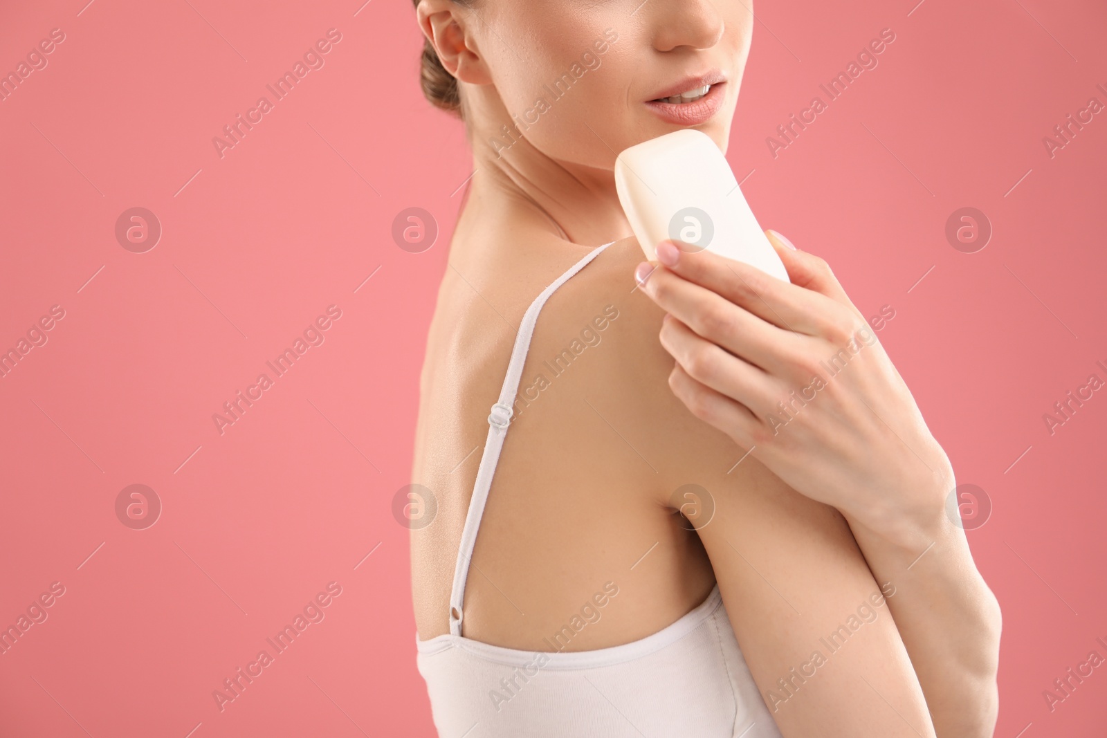 Woman with soap bar on pink background, closeup. Space for text Photo of Woman with soap bar on pink background, closeup. Space for text