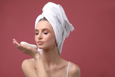 Photo of Beautiful woman with soap bar on pink background