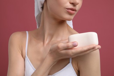 Photo of Woman with soap bar on pink background, closeup