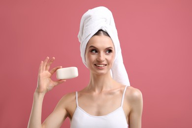 Photo of Smiling woman with soap bar on pink background