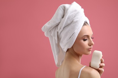Photo of Beautiful woman with soap bar on pink background. Space for text