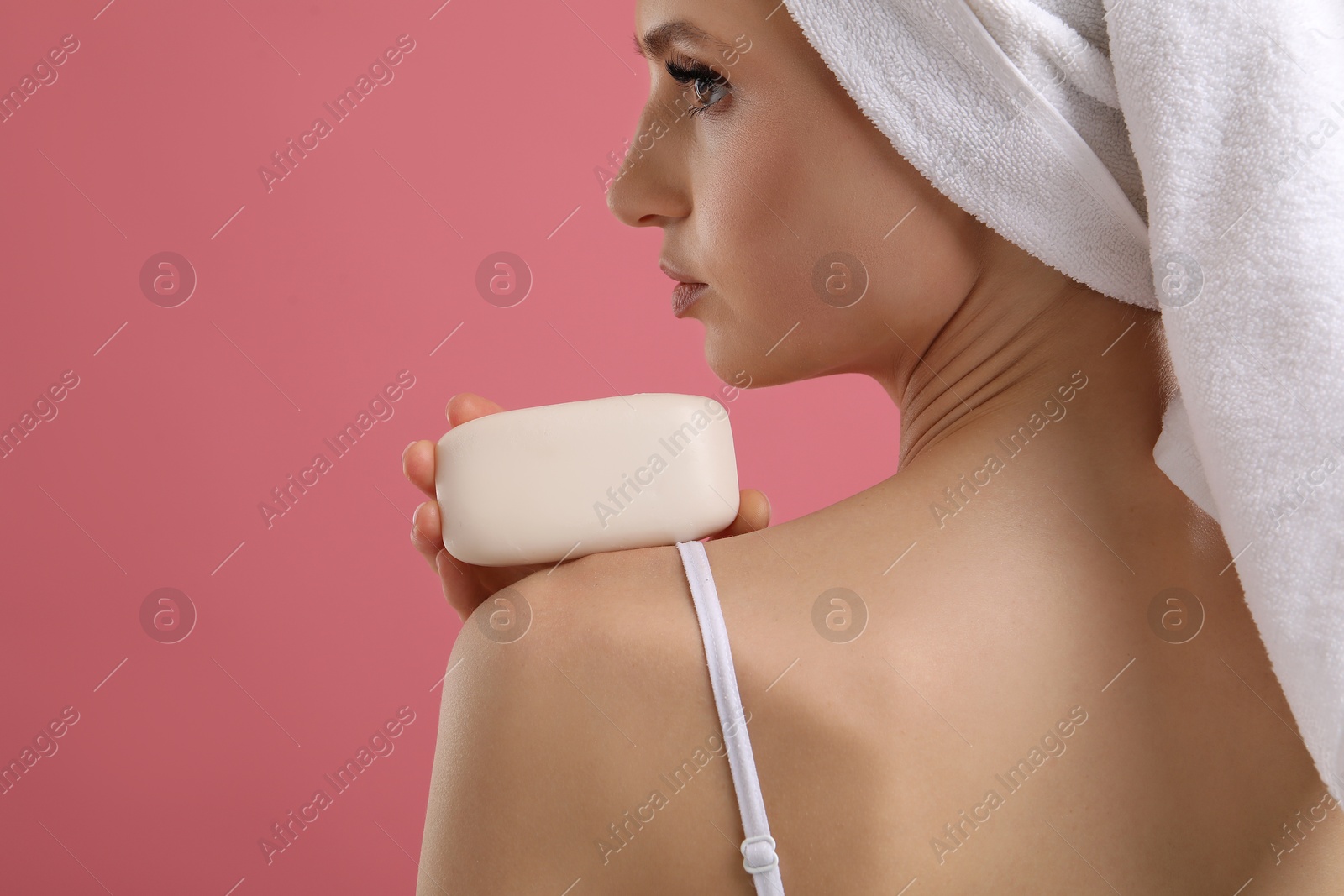Woman with soap bar on pink background, closeup. Space for text Photo of Woman with soap bar on pink background, closeup. Space for text
