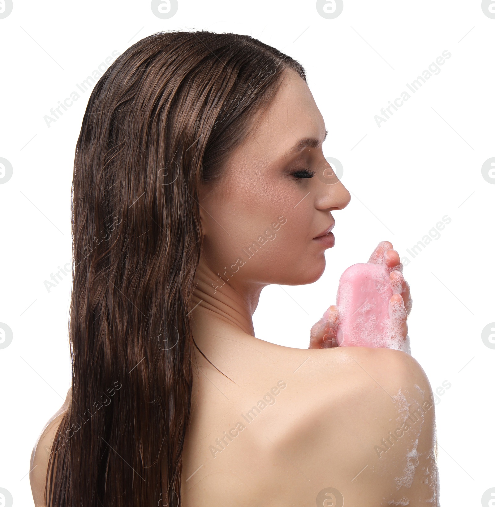 Photo of Beautiful woman washing body with soap bar on white background
