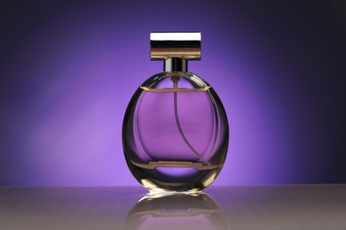 Photo of Bottle of perfume on mirror surface against purple gradient background