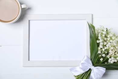 Photo of Bouquet of beautiful lily-of-the-valley flowers, coffee and blank frame on white wooden background, flat lay. Space for text