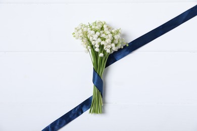 Photo of Bouquet of beautiful lily-of-the-valley flowers on white wooden background, top view